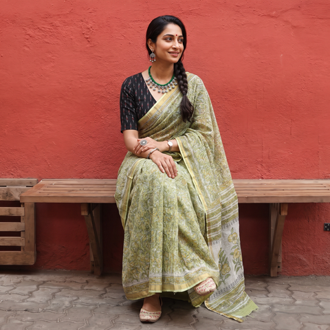 Olive green Sanganeri hand block print Kota Doria cotton saree by artisan Purushottam Chhipa, draped and worn by a woman, AI visual of the saree, iTokri