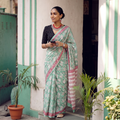 Mint green and pink Sanganeri hand block print pure mul cotton ready to wear saree, draped and worn by a woman, AI visual of the saree, iTokri