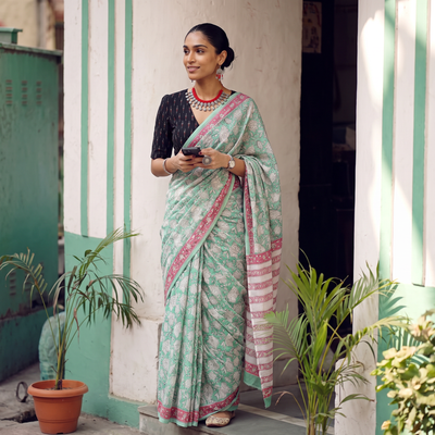 Mint green and pink Sanganeri hand block print pure mul cotton ready to wear saree, draped and worn by a woman, AI visual of the saree, iTokri