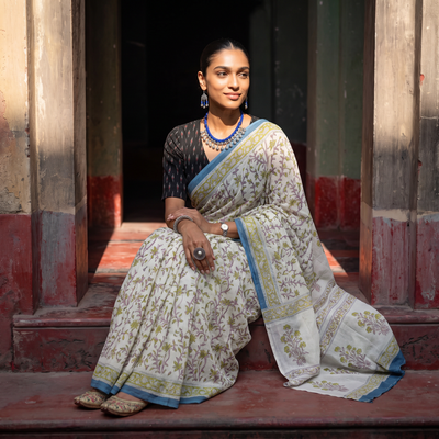 Cream and blue Sanganeri hand block print pure mul cotton ready to wear saree, draped and worn by a woman, AI visual of the saree, iTokri