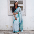 White and teal Sanganeri hand block print pure mul cotton ready to wear saree, draped and worn by a woman, AI visual of the saree, iTokri