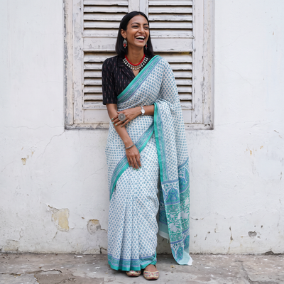 White and teal Sanganeri hand block print pure mul cotton ready to wear saree, draped and worn by a woman, AI visual of the saree, iTokri