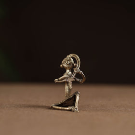 Sitting lady with braising her hair tribal odisha dokra art