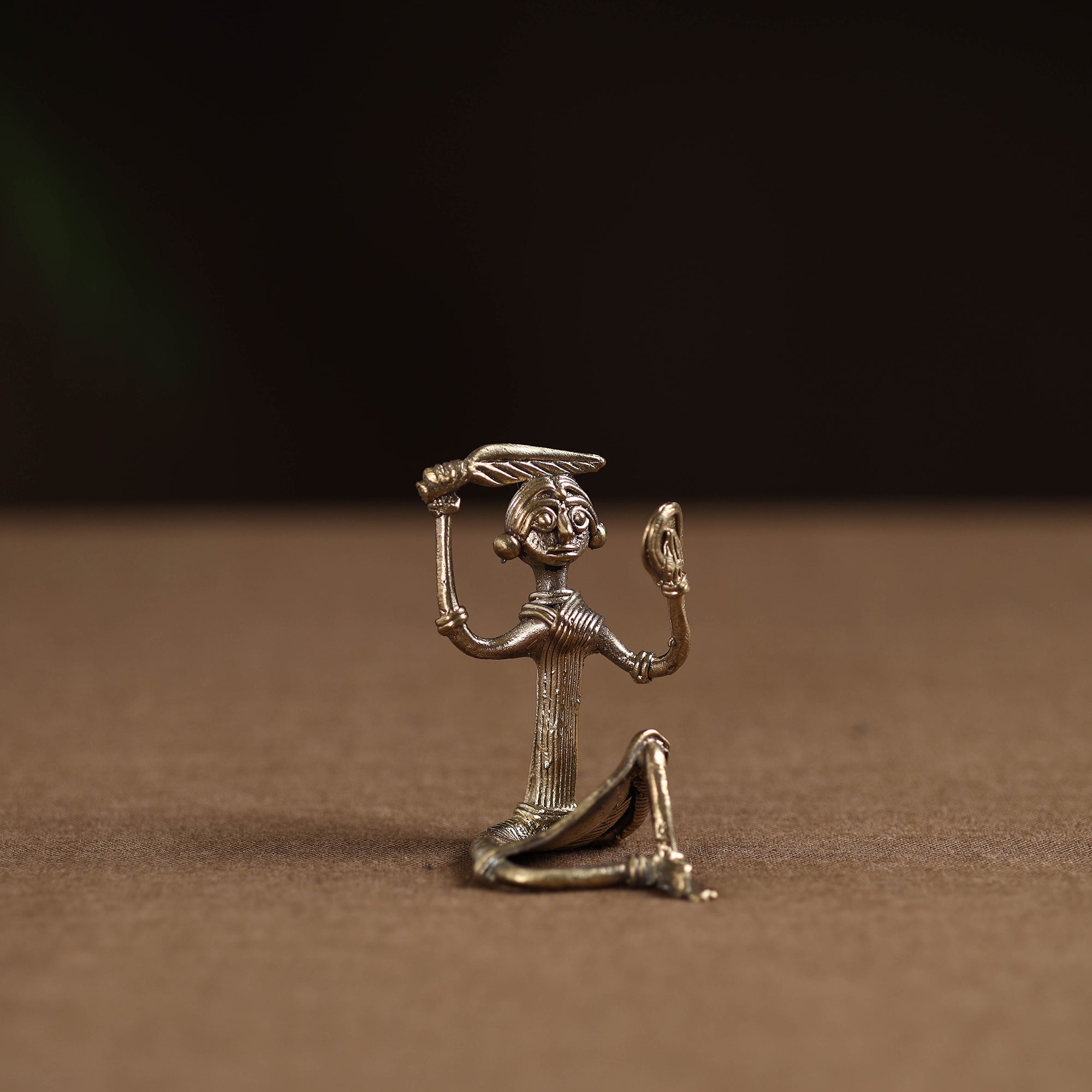 Sitting lady with combing hair tribal odisha dokra art