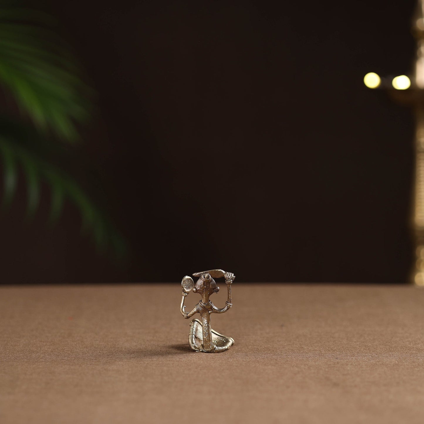 Sitting lady with combing hair tribal odisha dokra art