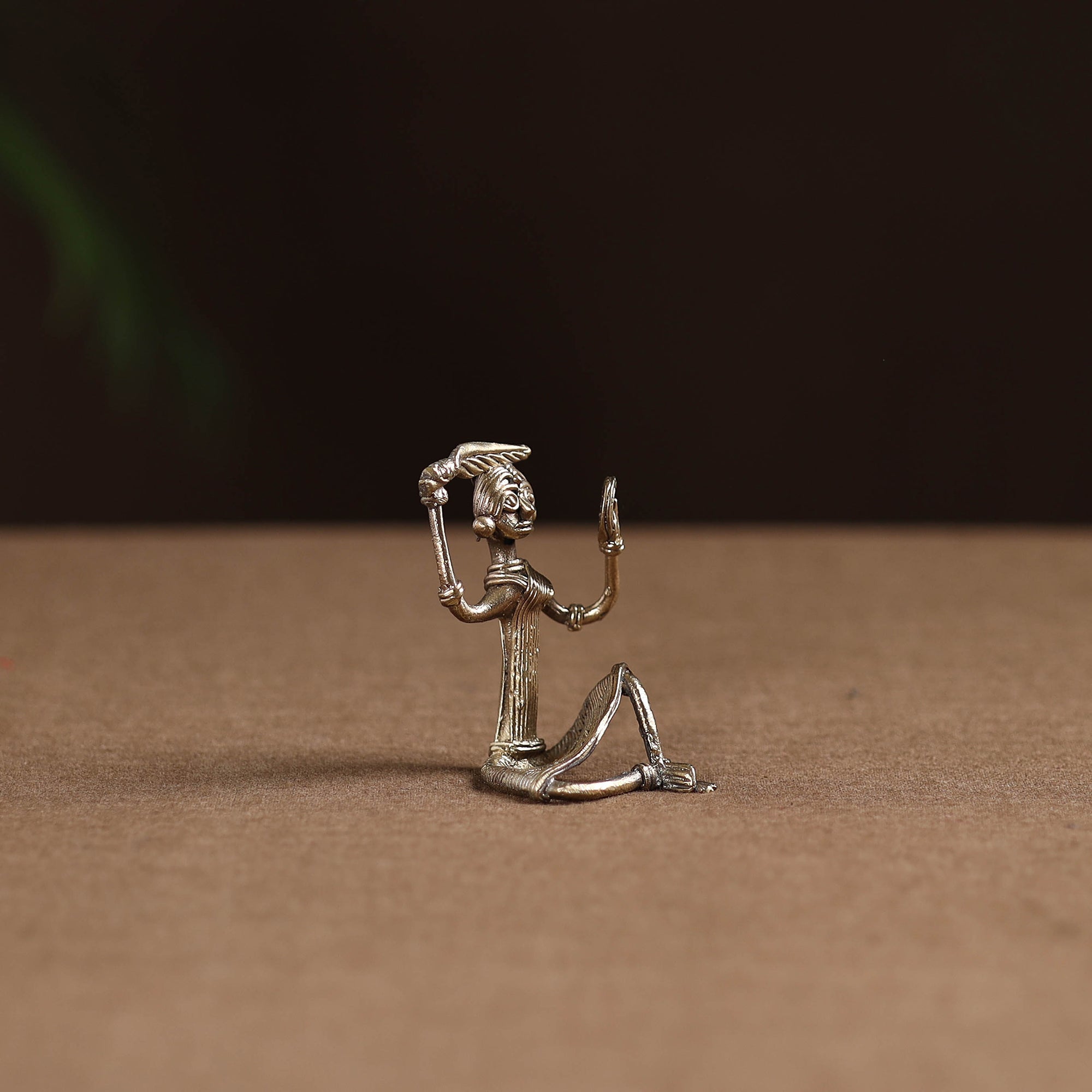 Sitting lady with combing hair tribal odisha dokra art