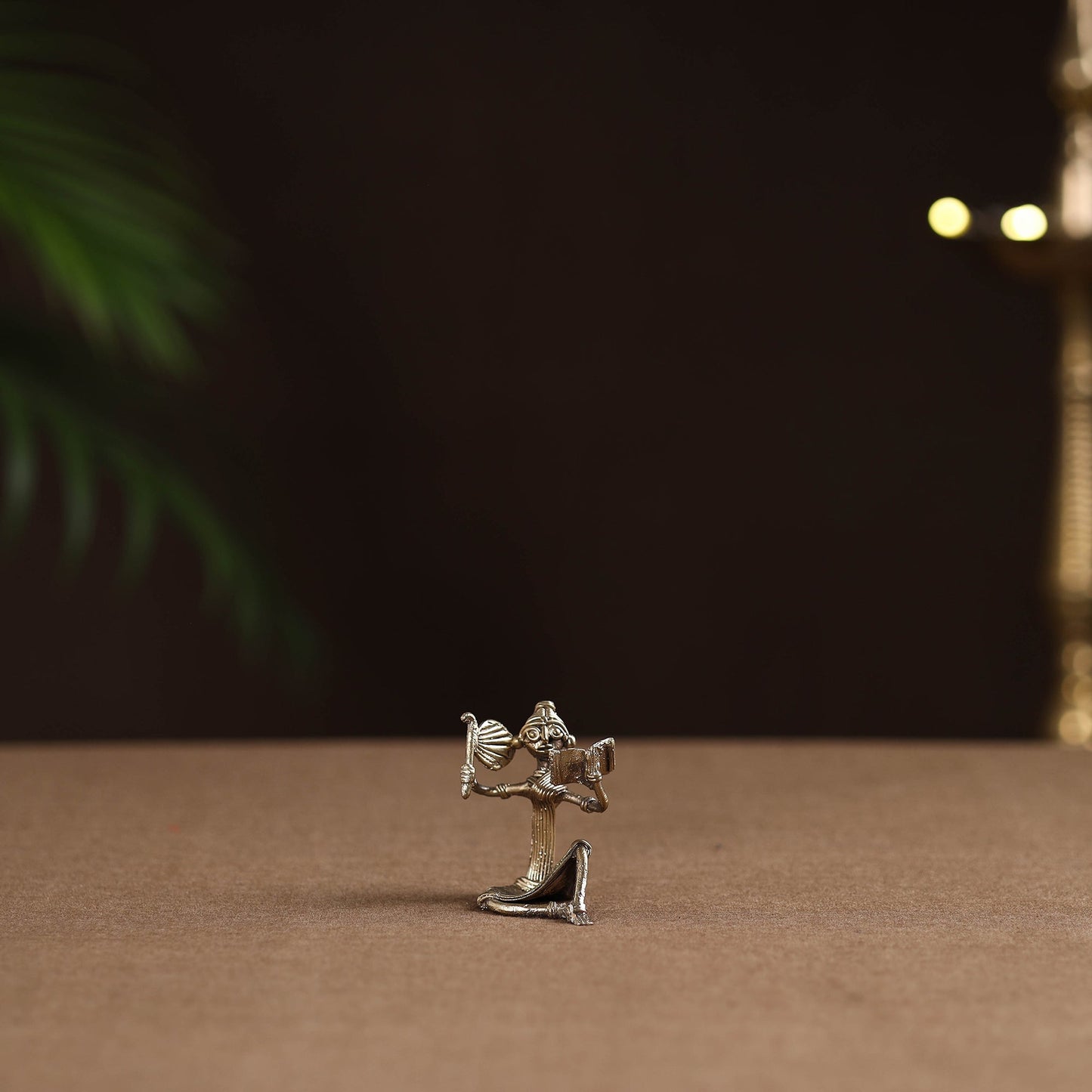 Sitting lady with reading book tribal odisha dokra art