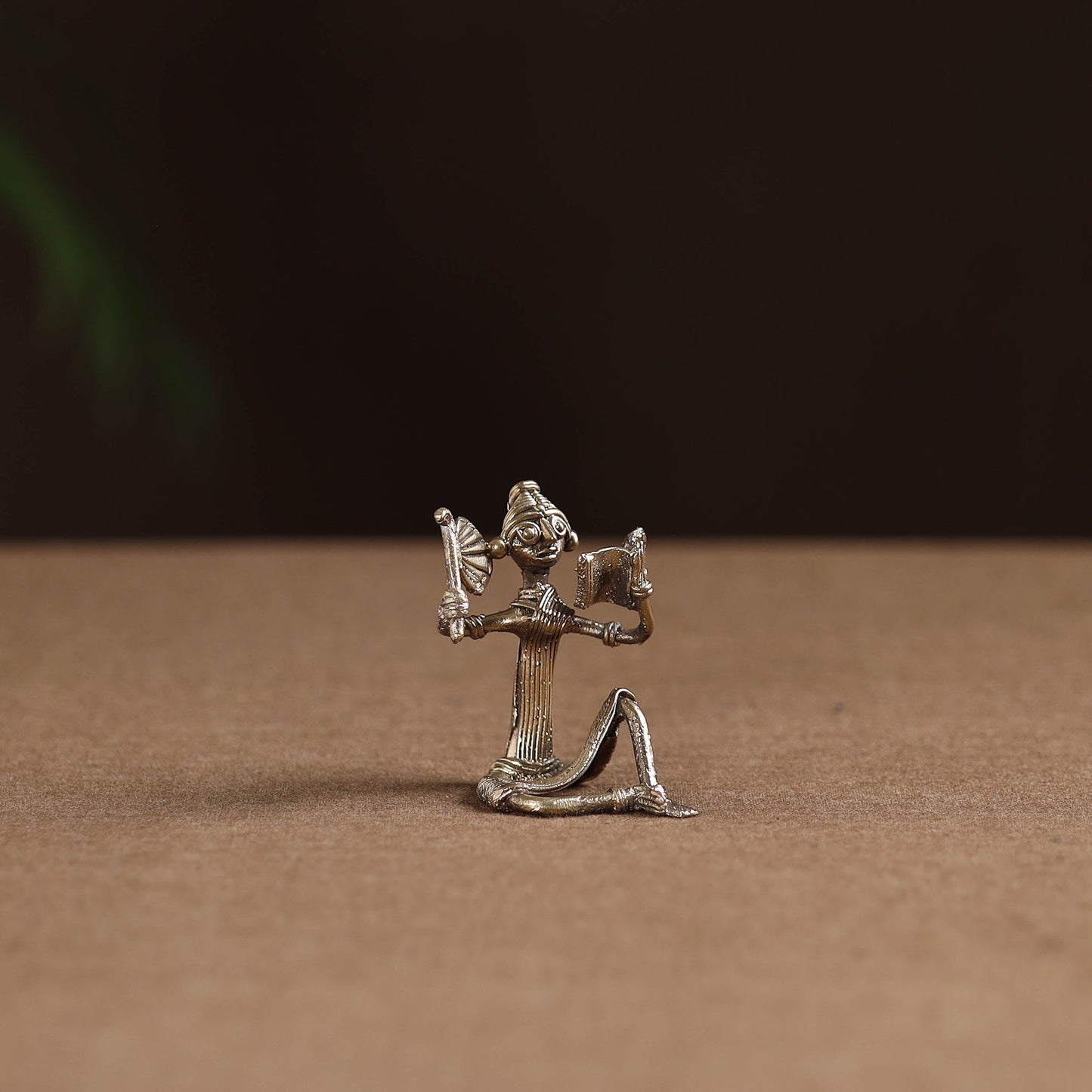 Sitting lady with reading book tribal odisha dokra art