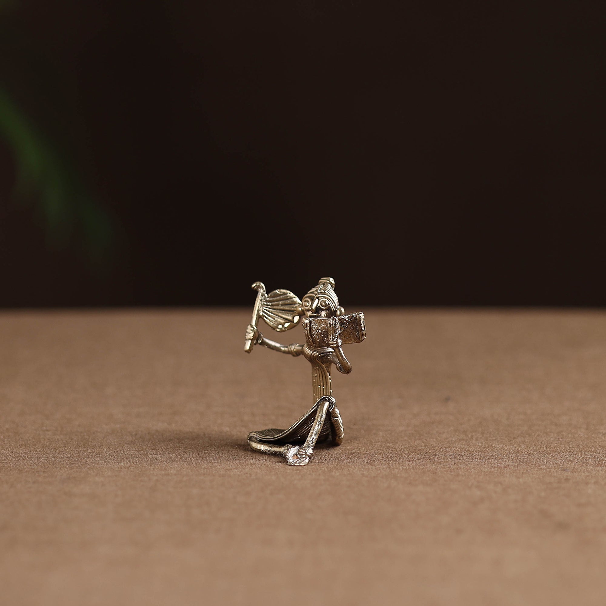 Sitting lady with reading book tribal odisha dokra art