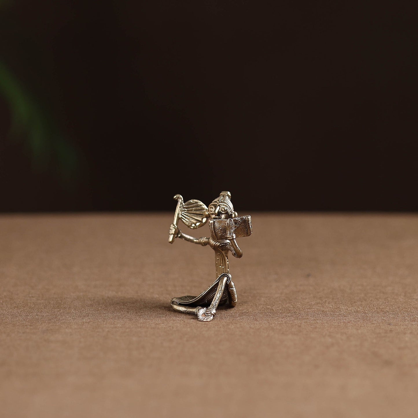 Sitting lady with reading book tribal odisha dokra art