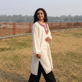 White Sozni Hand Embroidered Kashmiri Merino Wool Pheran, worn by a model, AI visual of the pheran, iTokri