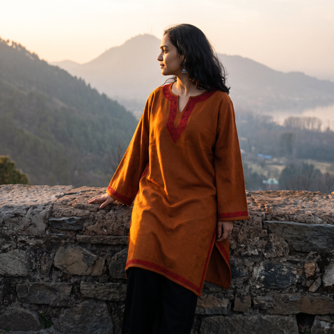 Orange Sozni Hand Embroidered Kashmiri Merino Wool Pheran, worn by a model, AI visual of the pheran, iTokri