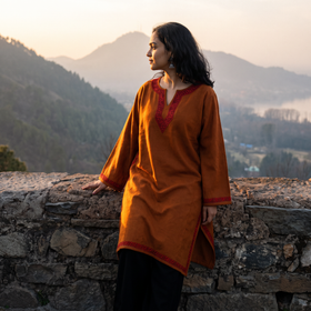 Orange Sozni Hand Embroidered Kashmiri Merino Wool Pheran, worn by a model, AI visual of the pheran, iTokri