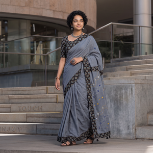 Grey Tagai & Mirror Embroidered Ajrakh Patchwork Pure Mul Cotton Saree with Blouse Piece, draped and worn by a woman, AI visual of the saree, iTokri