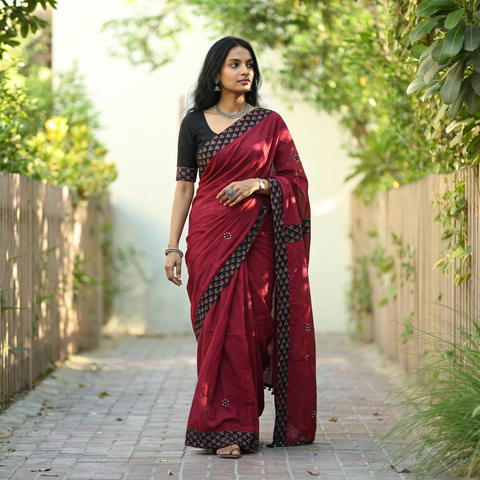 Maroon Tagai & Mirror Embroidered Ajrakh Patchwork Pure Mul Cotton Saree with Blouse Piece, draped and worn by a woman, AI visual of the saree, iTokri
