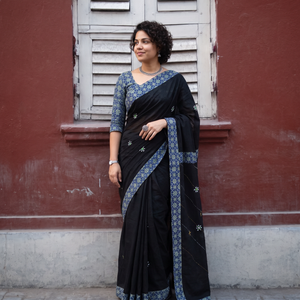 Black Tagai & Mirror Embroidered Ajrakh Patchwork Pure Mul Cotton Saree with Blouse Piece, draped and worn by a woman, AI visual of the saree, iTokri