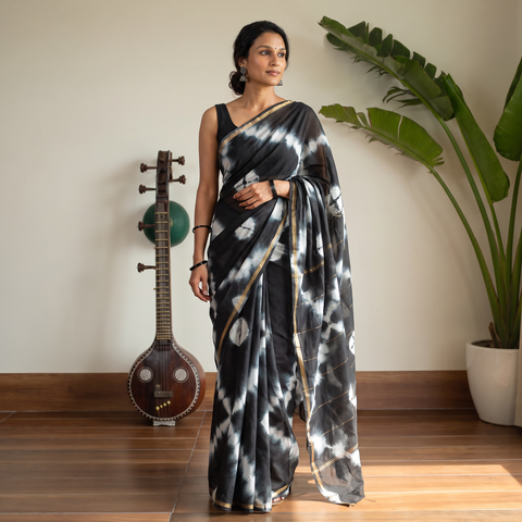 Black Tie & Dye Chanderi Silk Shibori Saree with Zari Border, draped and worn by a woman, AI visual of the saree, iTokri