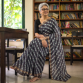 Black Tie-Dye Mothra Chanderi Silk Leheriya Saree with Zari Border, draped and worn by a woman, AI visual of the saree, iTokri