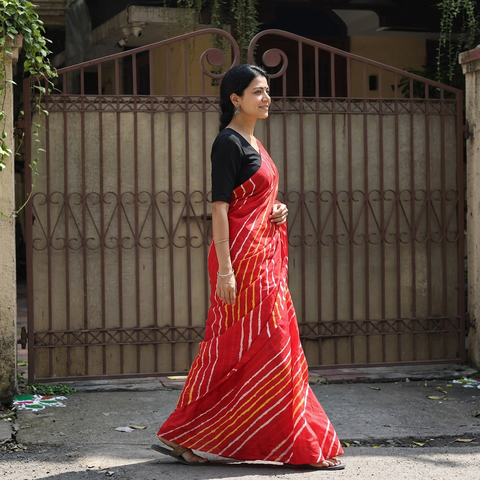 Red Tie-Dye Mulberry Silk Handloom Leheriya Saree, draped and worn by a woman, AI visual of the saree, iTokri