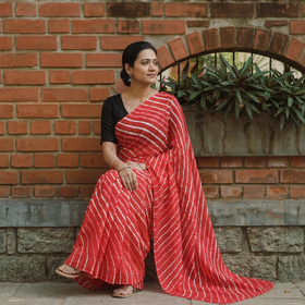 Red Tie-Dye Mulberry Silk Handloom Leheriya Saree, draped and worn by a woman, AI visual of the saree, iTokri