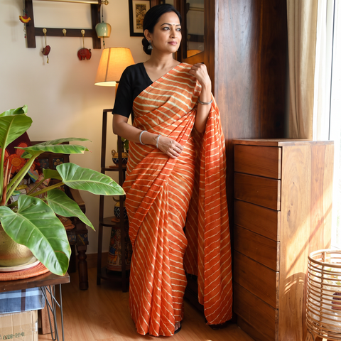 Orange Tie-Dye Tussar Silk Handloom Leheriya Saree, draped and worn by a woman, AI visual of the saree, iTokri