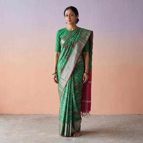 Green Traditional Pochampally Ikat Handwoven Pure Silk Pattu Saree with Rudraksha Border, draped and worn by a woman, AI visual of the saree, iTokri