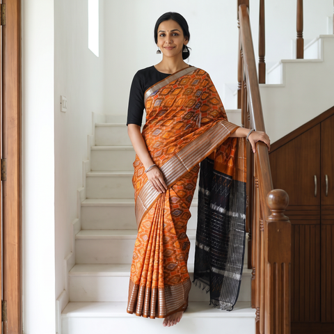 Orange Traditional Pochampally Ikat Handwoven Pure Silk Pattu Saree with Rudraksha Border, draped and worn by a woman, AI visual of the saree, iTokri