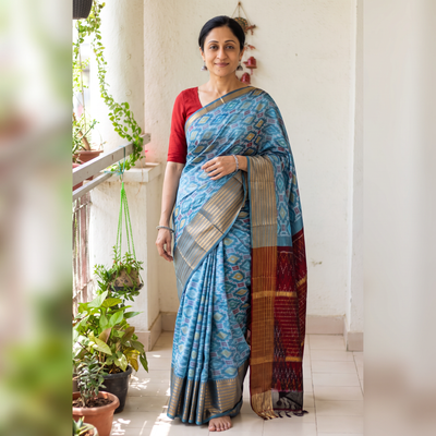 Blue Traditional Pochampally Ikat Handwoven Pure Silk Pattu Saree with Rudraksha Border, draped and worn by a woman, AI visual of the saree, iTokri