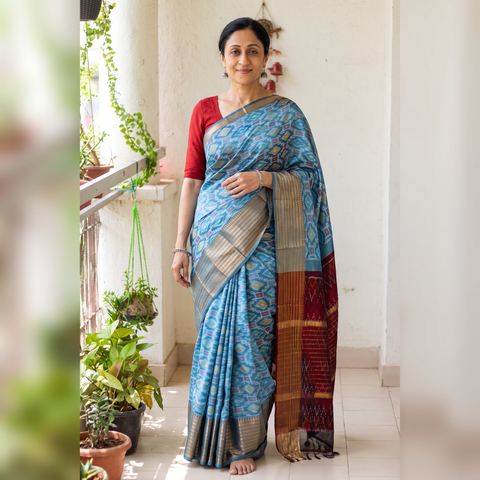 Blue Traditional Pochampally Ikat Handwoven Pure Silk Pattu Saree with Rudraksha Border, draped and worn by a woman, AI visual of the saree, iTokri