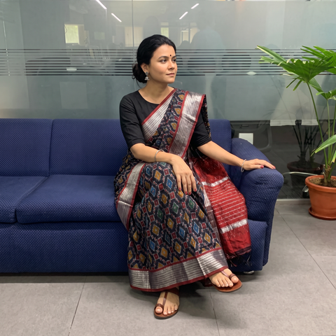 Black Traditional Pochampally Ikat Handwoven Pure Silk Pattu Saree with Rudraksha Border, draped and worn by a woman, AI visual of the saree, iTokri