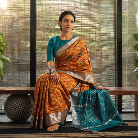 Orange Traditional Pochampally Ikat Handwoven Pure Silk Pattu Saree with Rudraksha Border, draped and worn by a woman, AI visual of the saree, iTokri