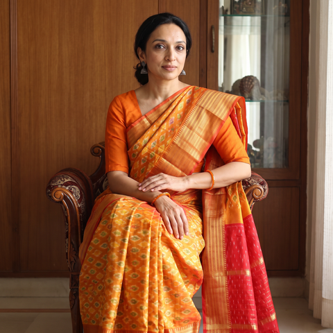 Yellow Traditional Pochampally Ikat Handwoven Pure Silk Pattu Saree with Rudraksha Border, draped and worn by a woman, AI visual of the saree, iTokri