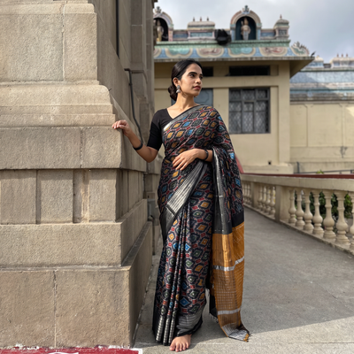 Black Traditional Pochampally Ikat Handwoven Pure Silk Pattu Saree with Rudraksha Border, draped and worn by a woman, AI visual of the saree, iTokri