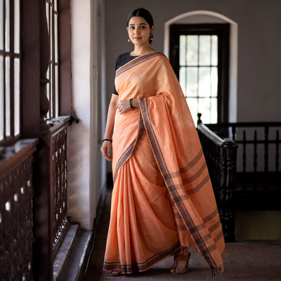 Peach Traditional Vidarbha Tussar Silk Cotton Handloom Saree with Woven Border, draped and worn by a woman, AI visual of the saree, iTokri