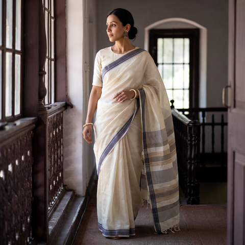 White Traditional Vidarbha Tussar Silk Handloom Saree with Woven Border, draped and worn by a woman, AI visual of the saree, iTokri