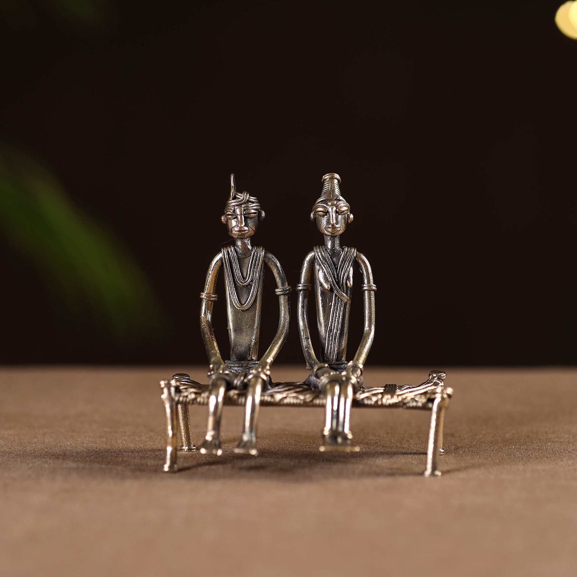 Couple sitting on cot - tribal odisha dokra handmade home