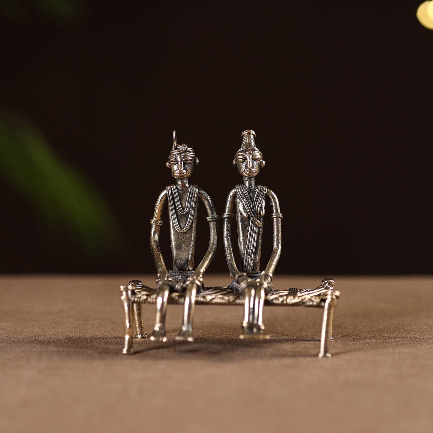 Couple sitting on cot - tribal odisha dokra handmade home