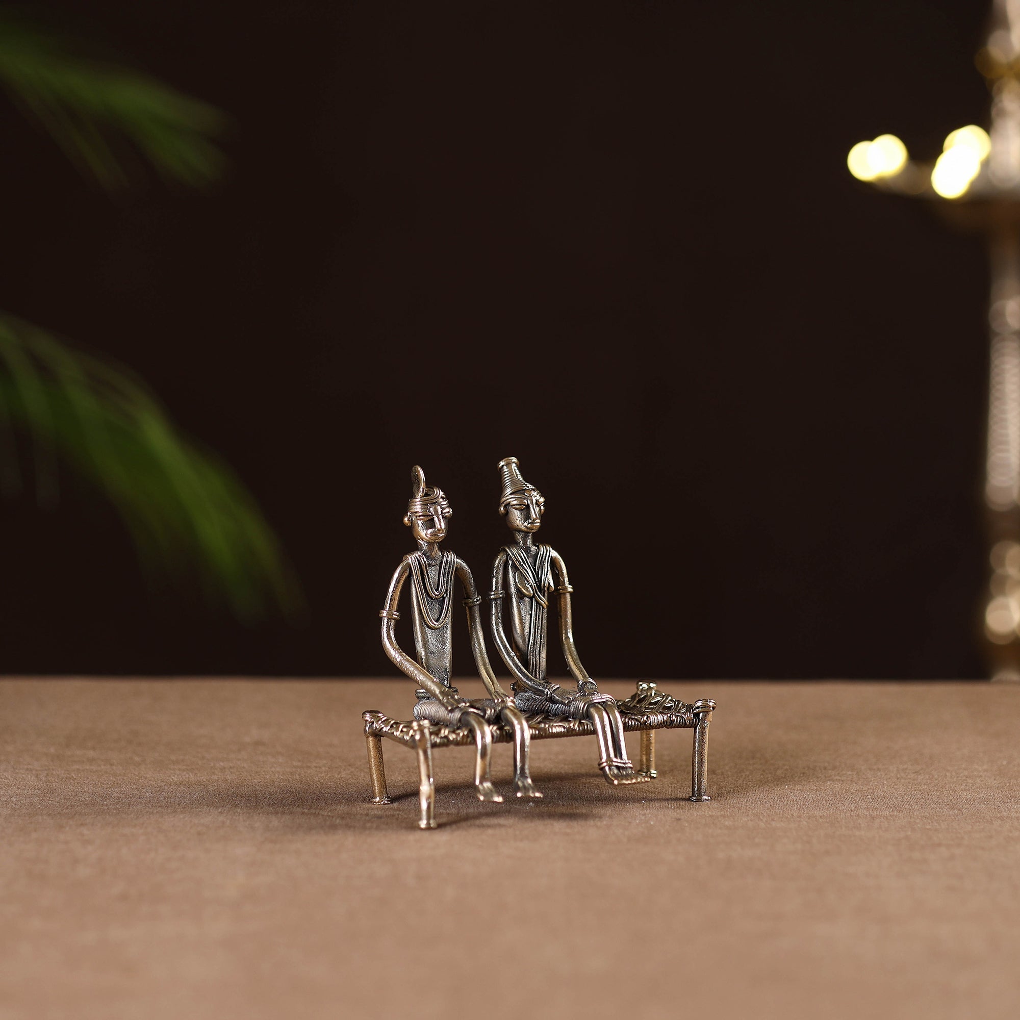 Couple sitting on cot - tribal odisha dokra handmade home