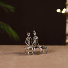 Couple sitting on cot - tribal odisha dokra handmade home