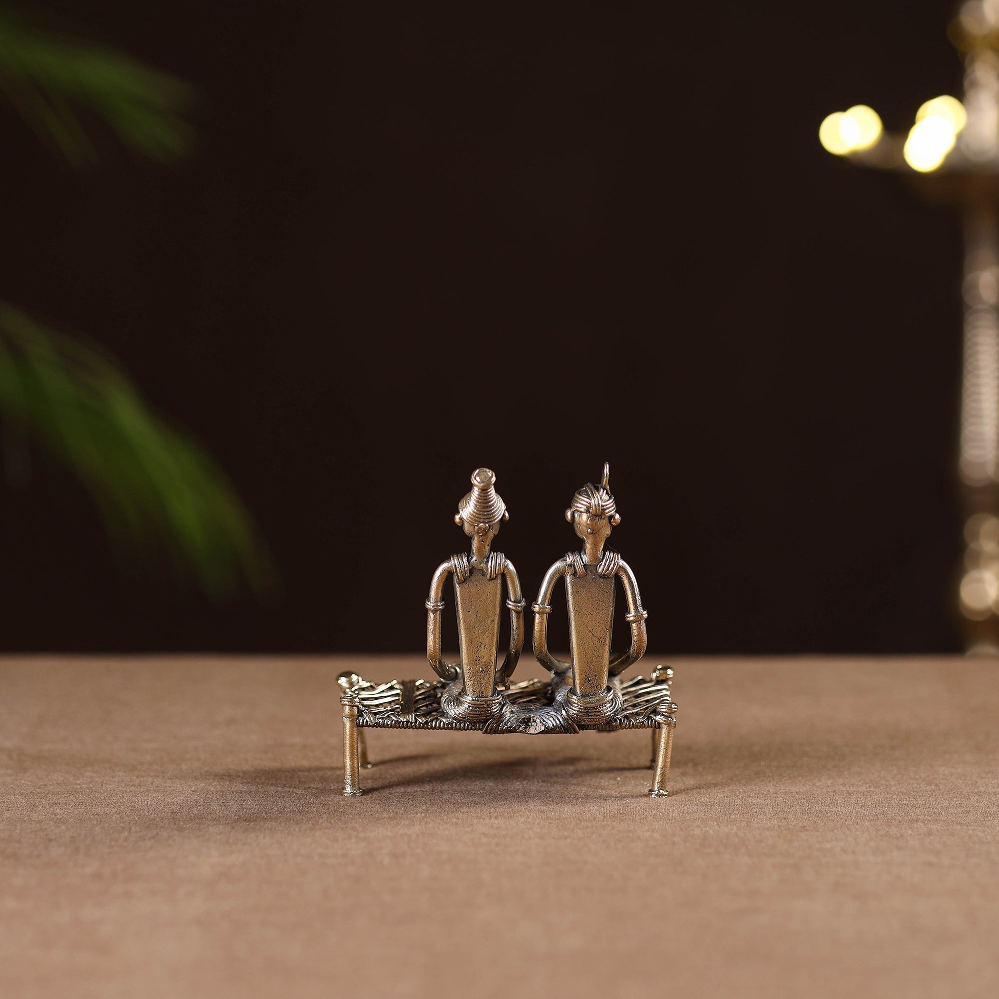 Couple sitting on cot - tribal odisha dokra handmade home