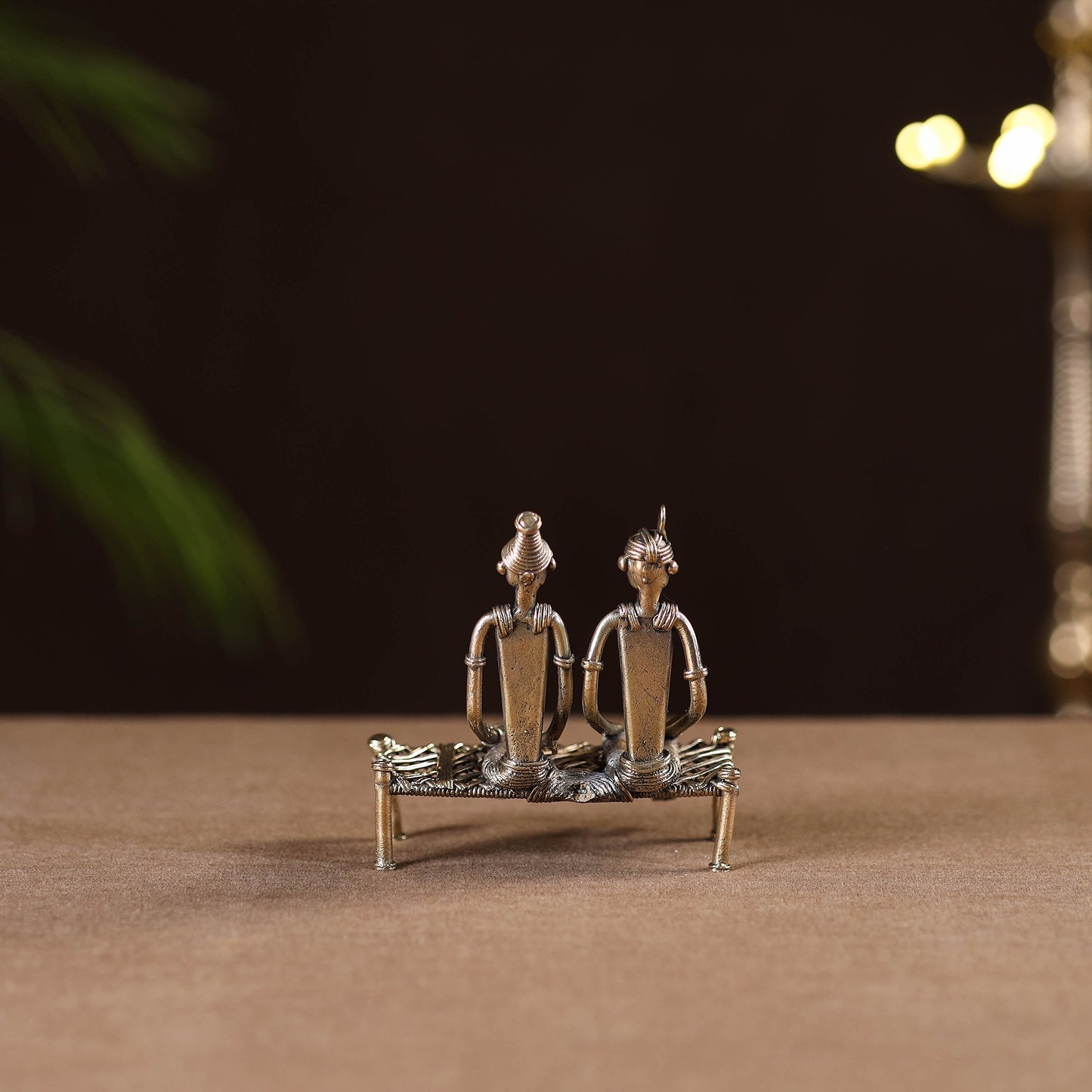 Couple sitting on cot - tribal odisha dokra handmade home