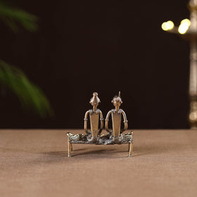 Couple sitting on cot - tribal odisha dokra handmade home