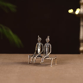 Couple sitting on cot - tribal odisha dokra handmade home