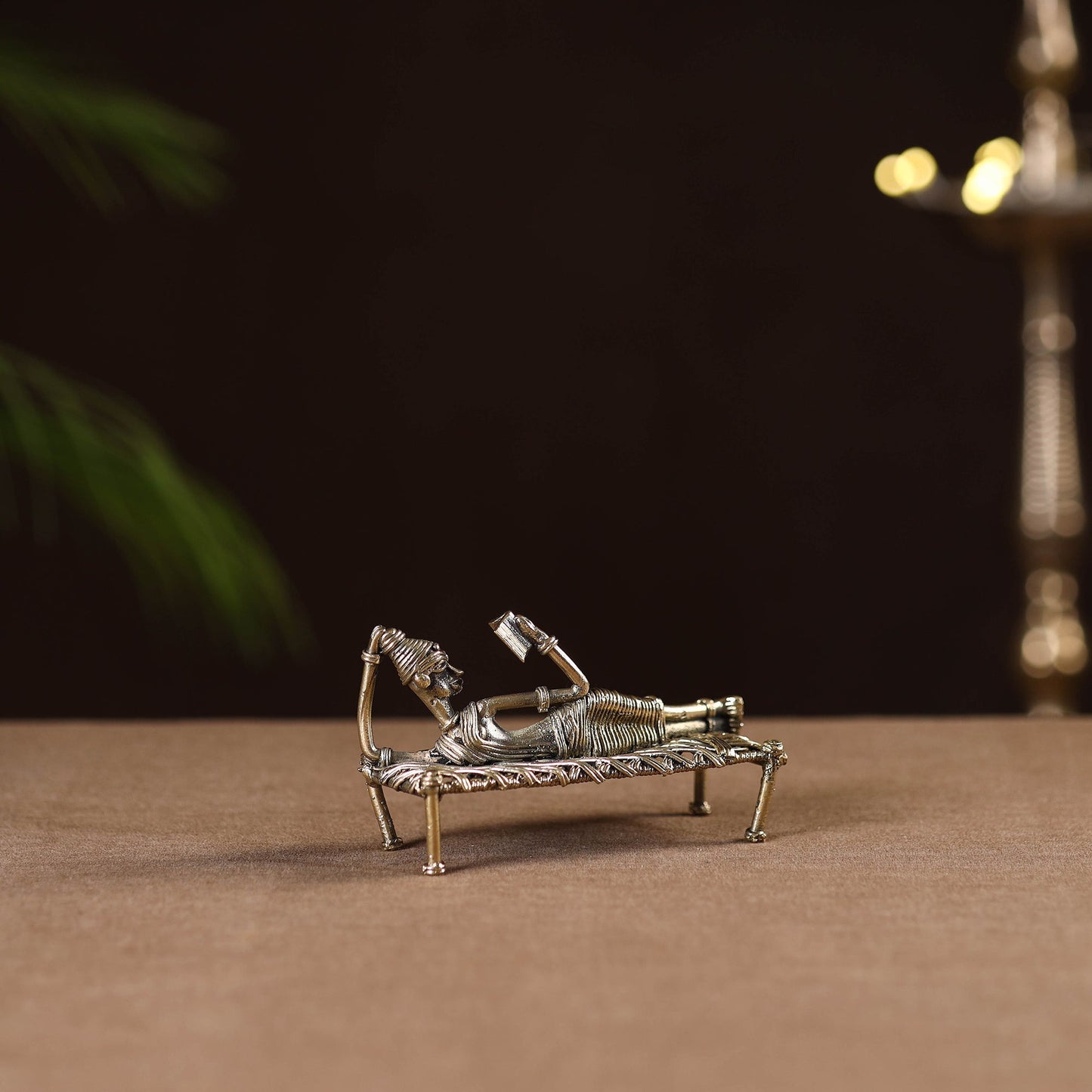 Sleeping reading women on cot - tribal odisha dokra