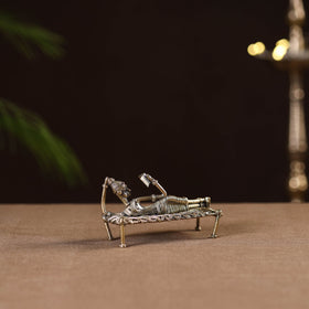 Sleeping reading women on cot - tribal odisha dokra