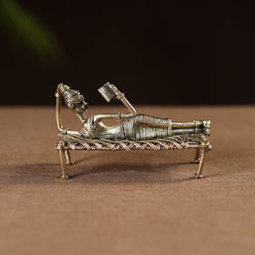 Sleeping reading women on cot - tribal odisha dokra