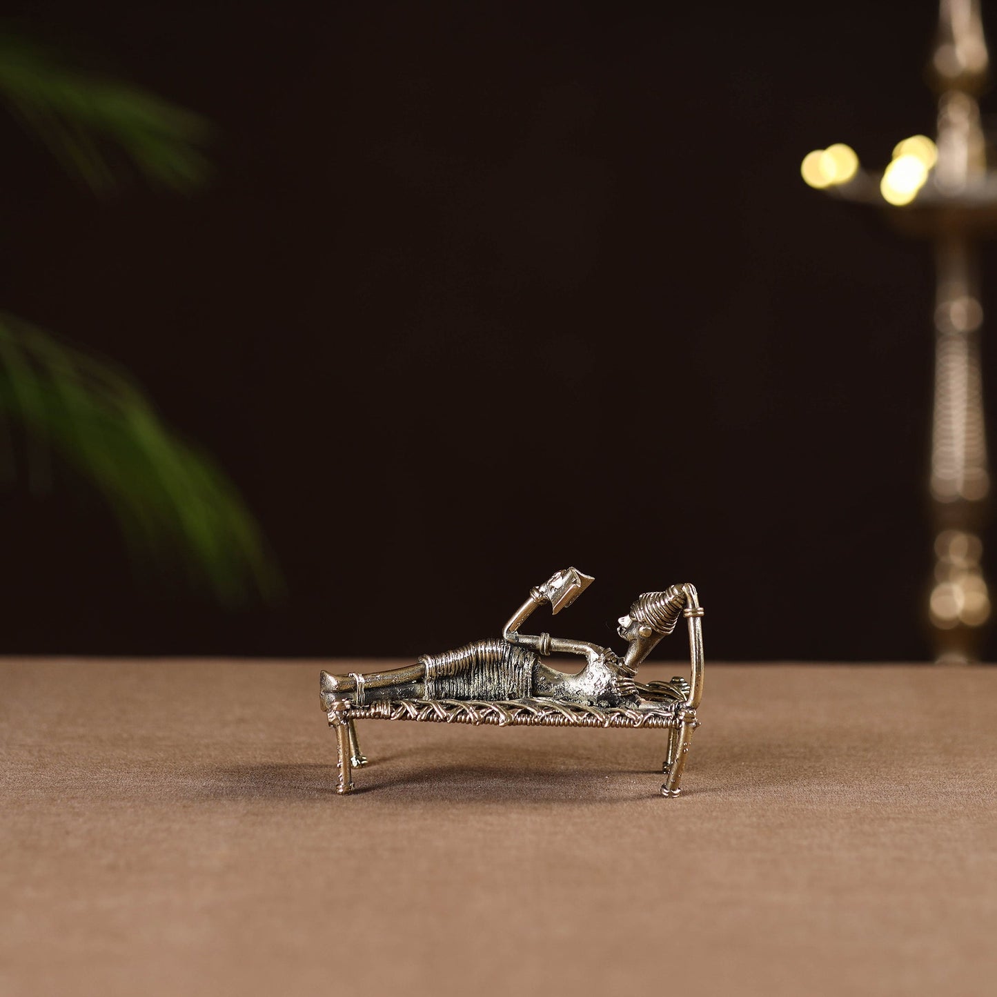 Sleeping reading women on cot - tribal odisha dokra