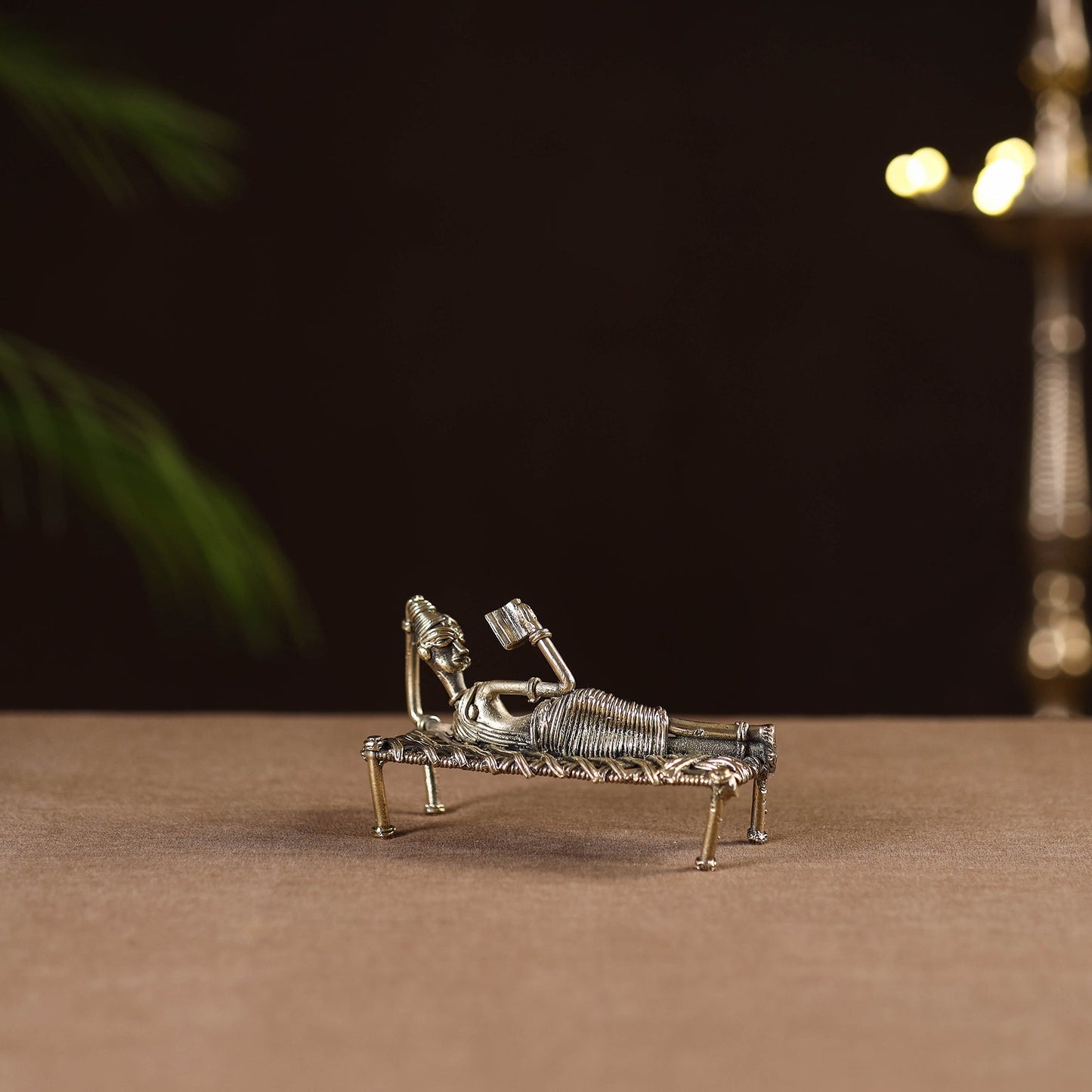 Sleeping reading women on cot - tribal odisha dokra