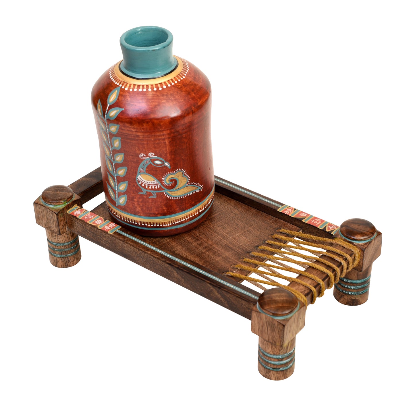 Rustic Red Madhubani Vase placed on Ethnic Charpai Stand